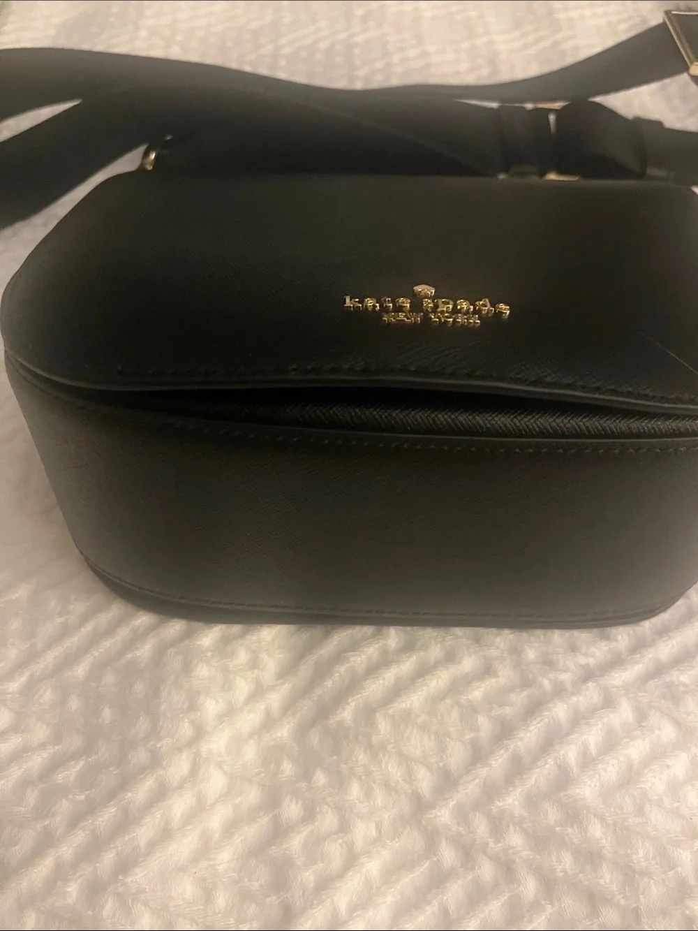 Kate Spade black crossbody saddlebag with gold logo